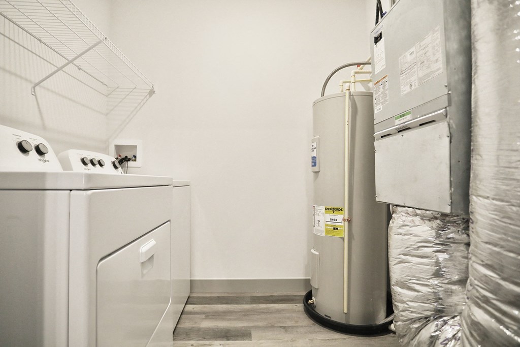 a laundry room with a washer and dryer in it and a white refrigerator