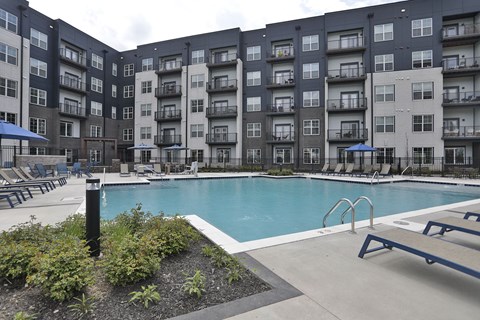 A large swimming pool surrounded by apartment buildings.