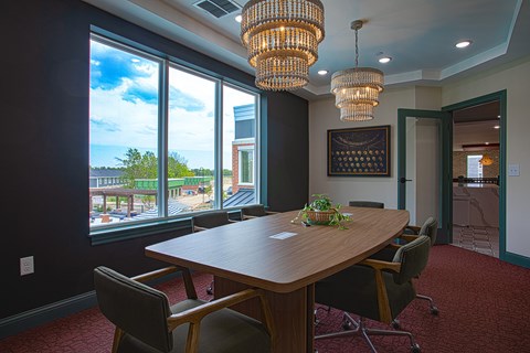 A conference room with a long table and chairs.