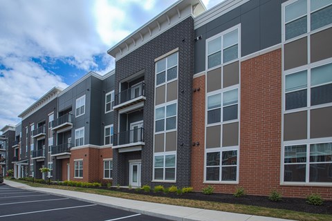 A row of modern apartment buildings with balconies and windows.