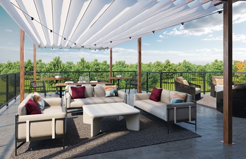 A patio with white couches and a white canopy.