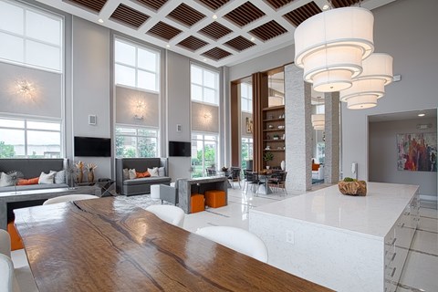 A modern kitchen with a wooden table and white chairs.