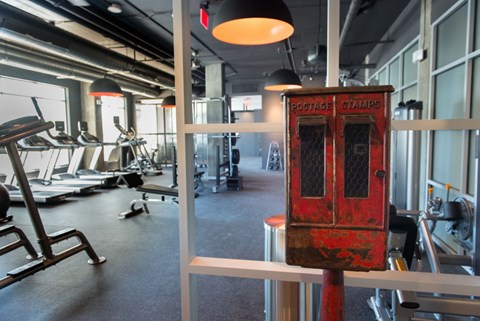 A gym with a red postage stamp machine.