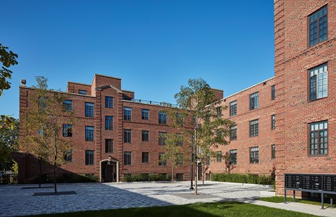 a large brick building with trees in front of it