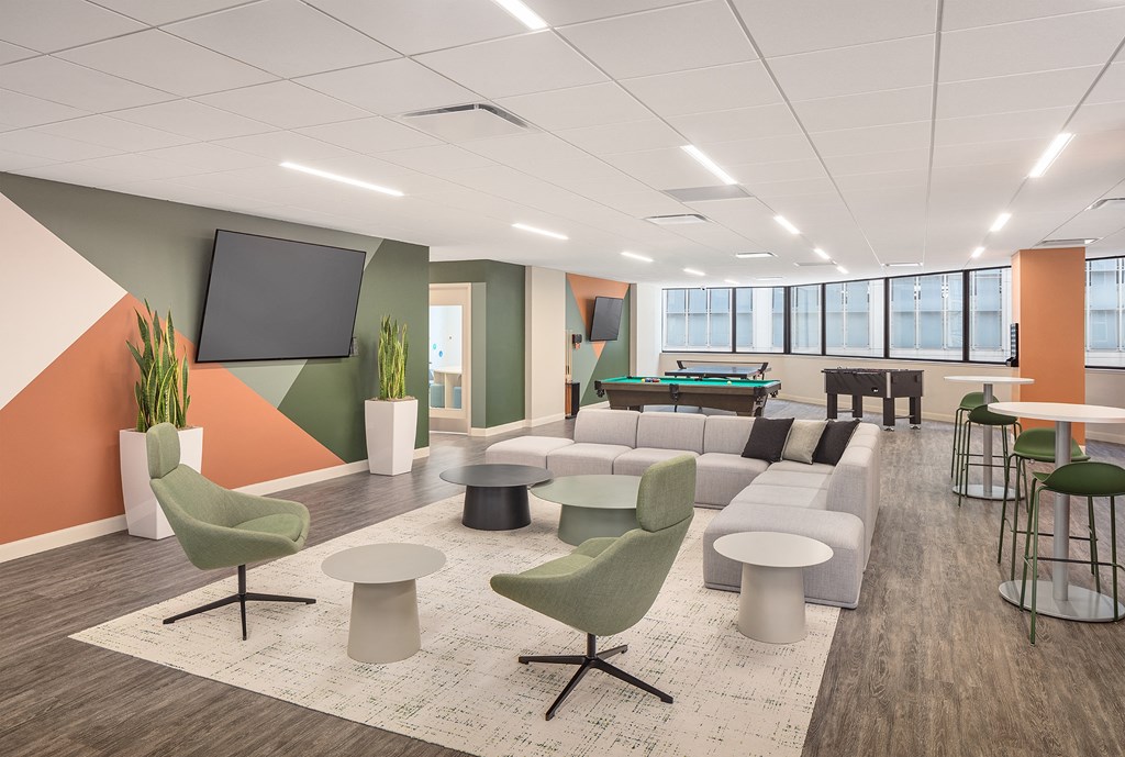 a lounge area with couches and chairs and a pool table