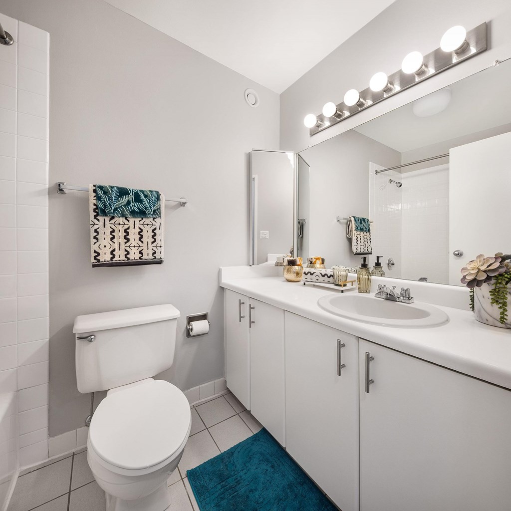 A white toilet is next to a sink in a bathroom.