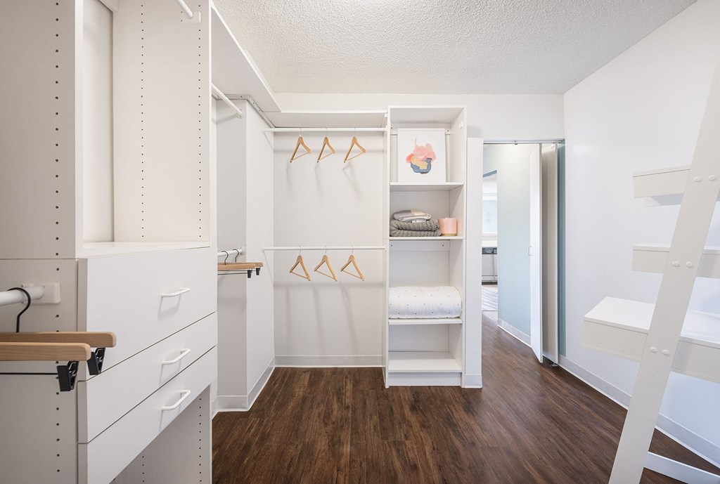 A white laundry room with a washer and dryer.