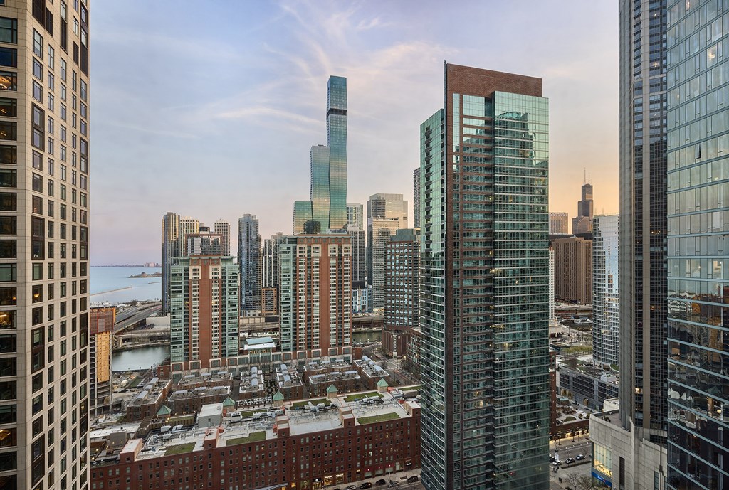 A cityscape with a mix of modern and older buildings, with a clear sky above.