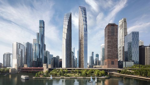 A cityscape with tall buildings and boats on the river.