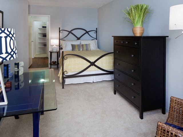a bedroom with a bed and a dresser