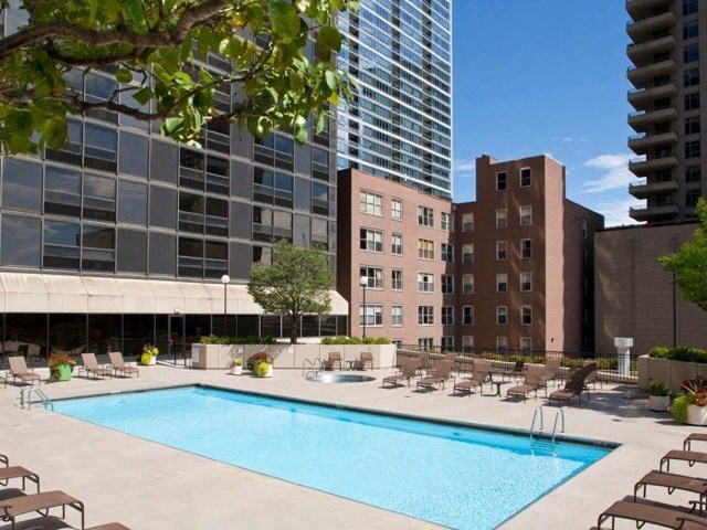 a swimming pool in front of a tall building