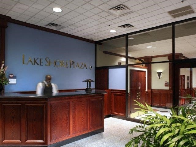 a person sitting at a desk in a lobby