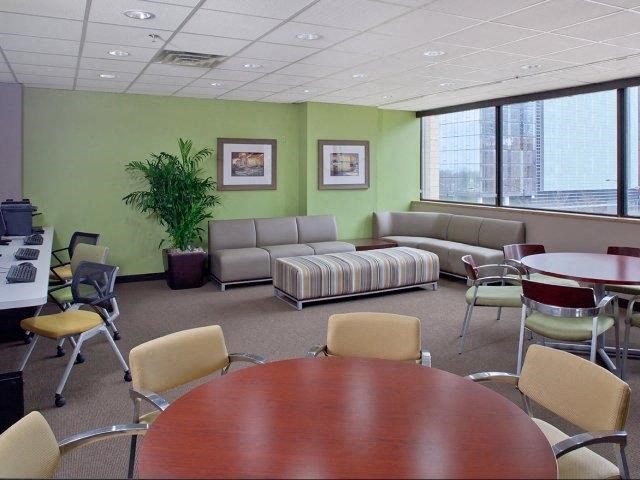 a living room with a table and chairs