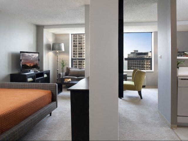 a hotel room with a bed and a television