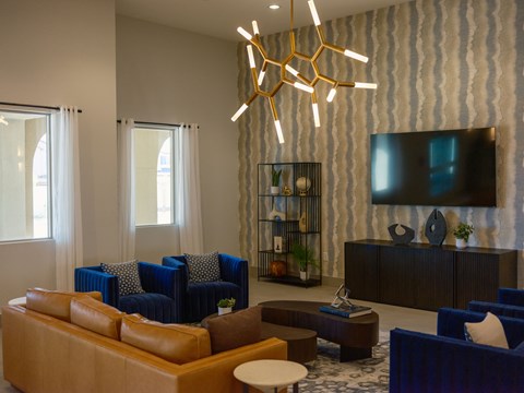 A modern living room with blue chairs and a wooden coffee table.