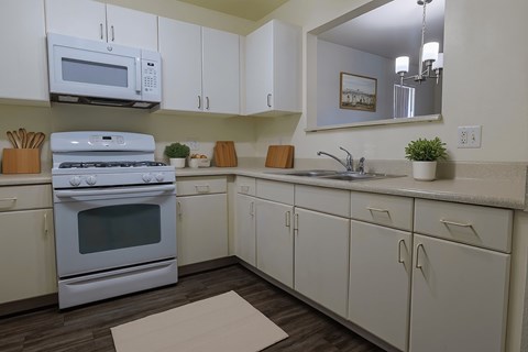 A white kitchen with a microwave above the stove.