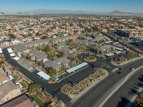 A bird's eye view of a residential area with a road running through it.