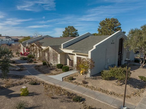 A sunny day at a residential area with houses and trees.