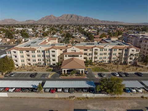 A large building with a parking lot in front of it.