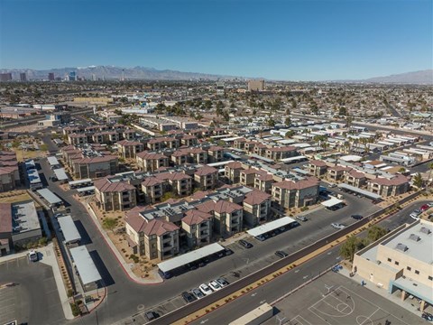 A view of a residential area with apartment buildings and a basketball court.