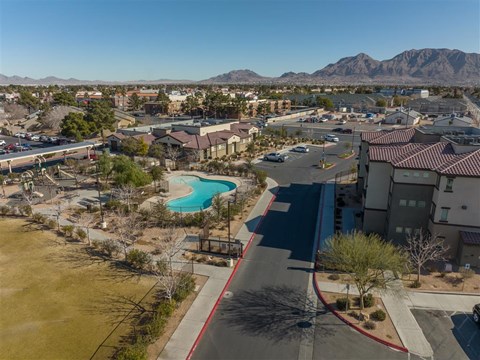 A view of a community with a pool and a road.