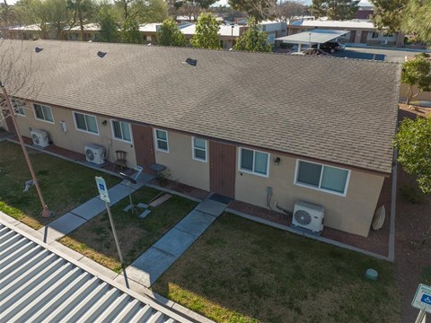 Apartment complex with a parking sign in front.