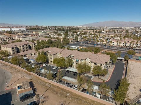 A residential area with houses and parked cars.