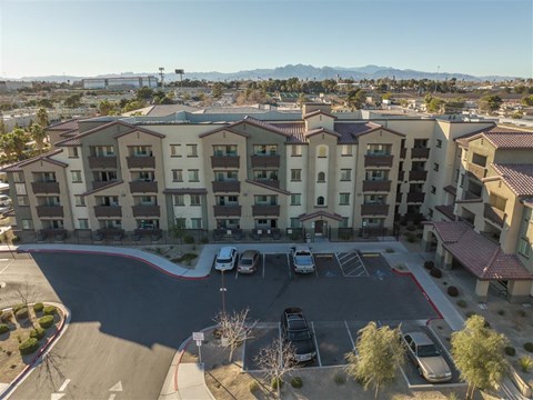 A parking lot in front of apartment buildings.