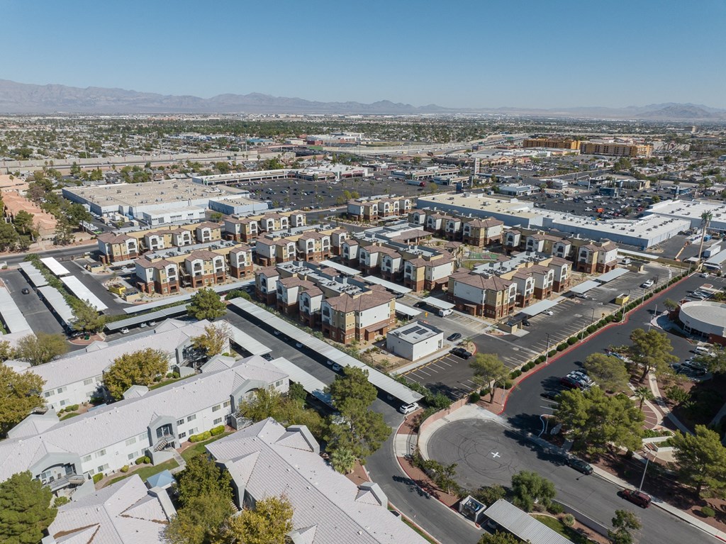 an aerial view of a city with houses and cars on the street