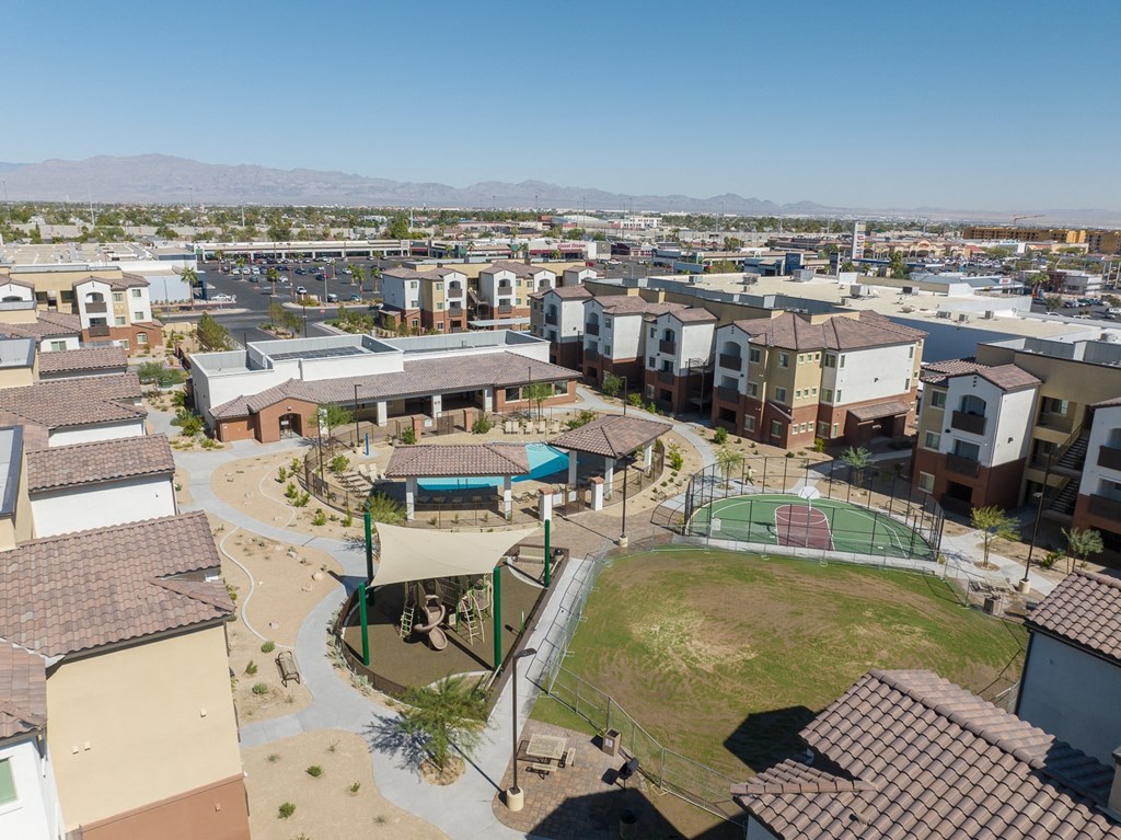an aerial view of a neighborhood with houses and a tennis court