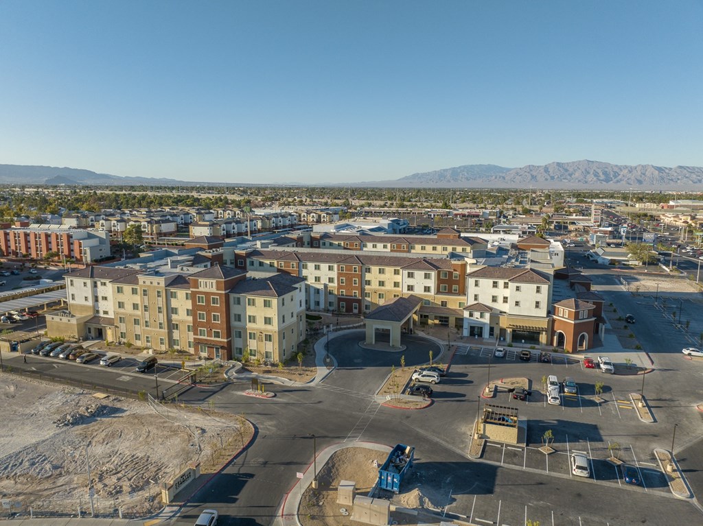 an aerial view of the city with mountains in the background