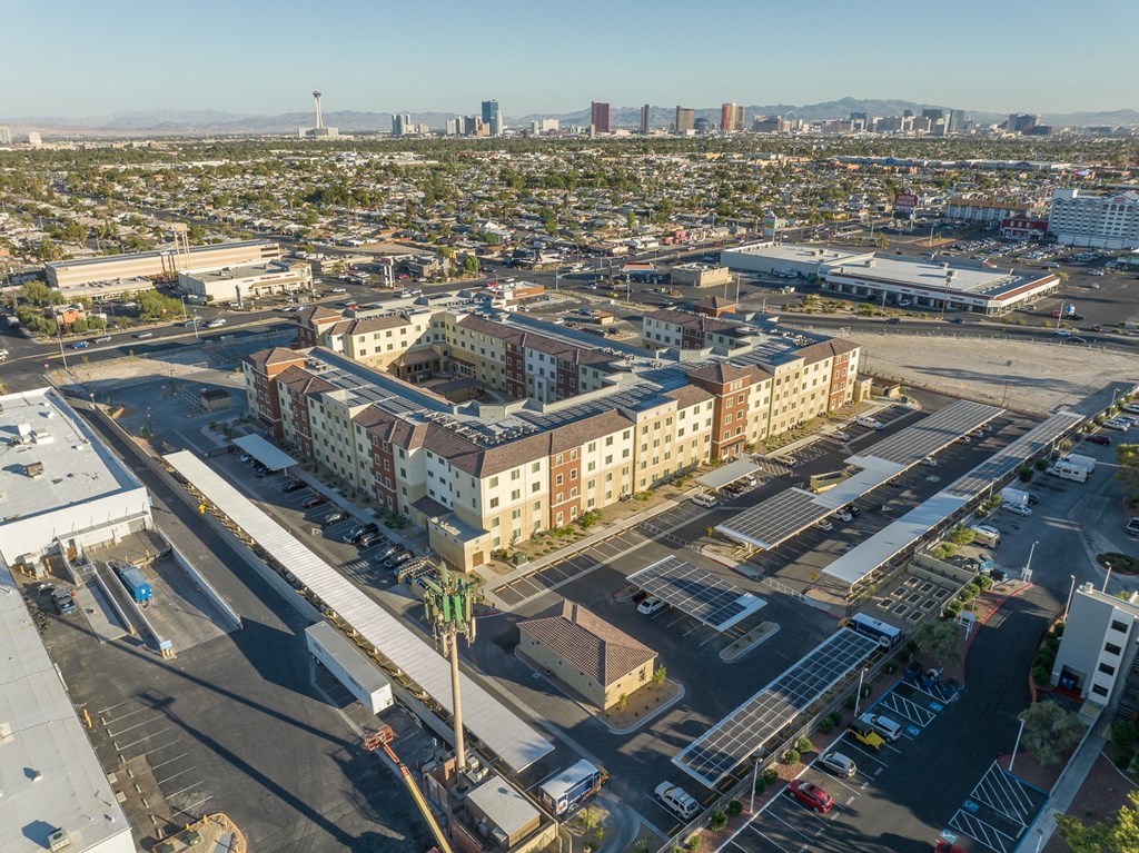 an aerial view of a city with buildings and a parking lot