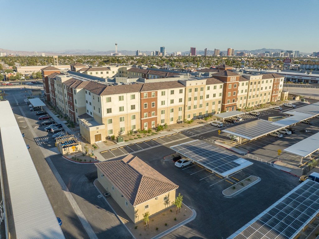 an aerial view of a parking lot with several buildings and solar panels