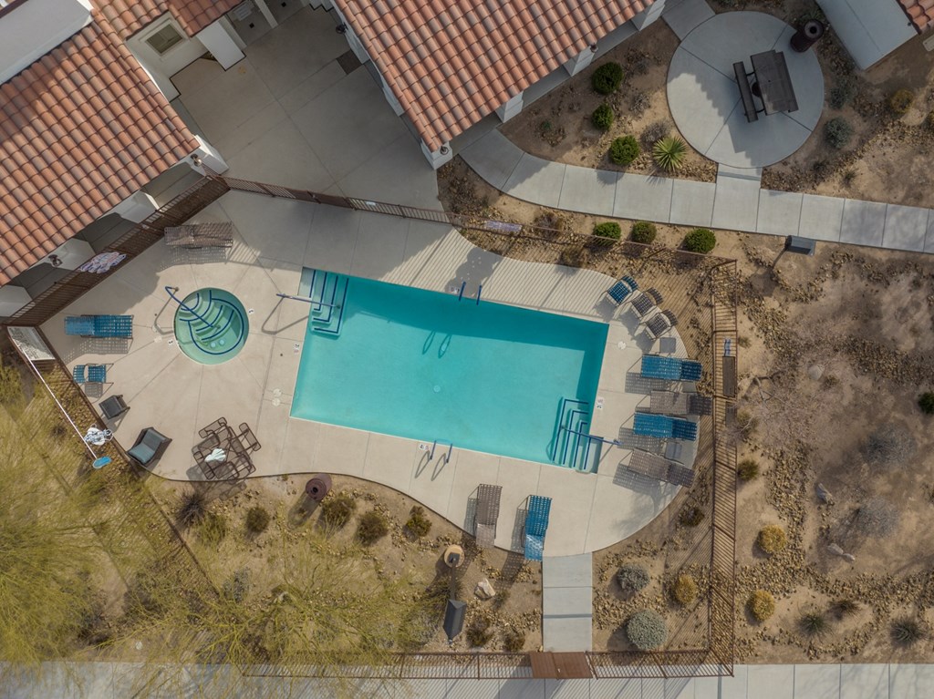 an aerial view of a swimming pool in a backyard of a house