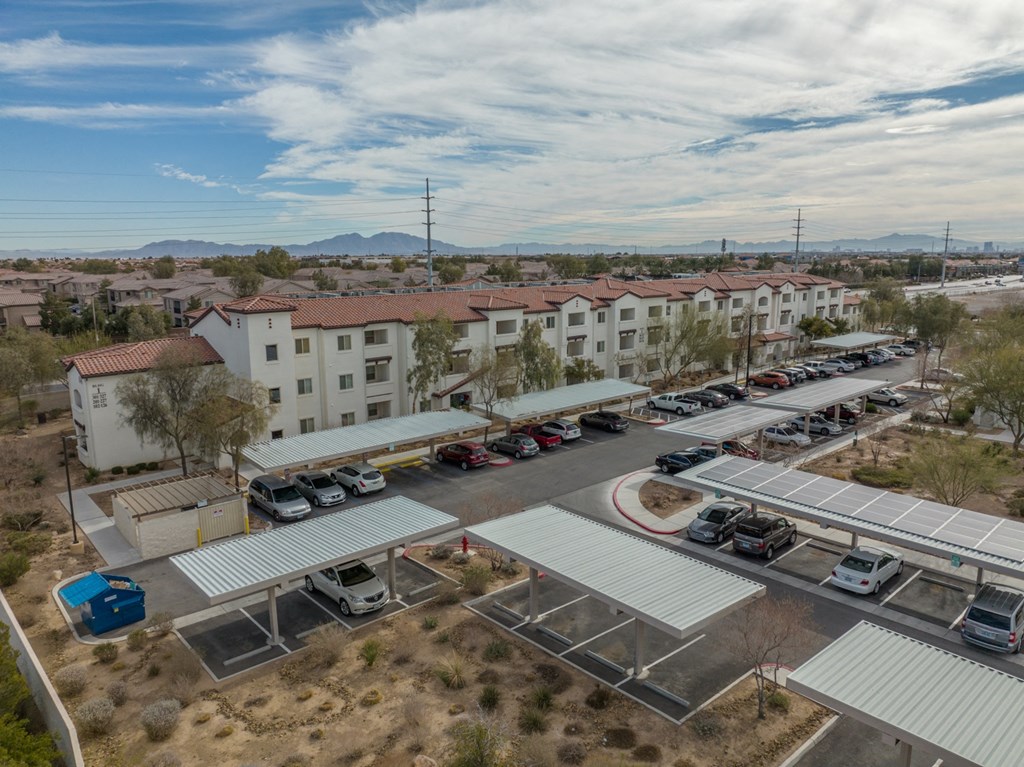 an aerial view of a parking lot with buildings and cars