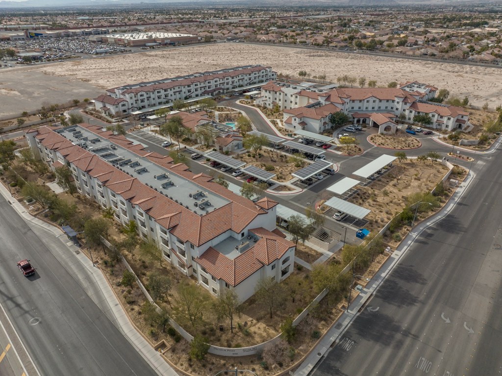 an aerial view of a city with buildings and a road