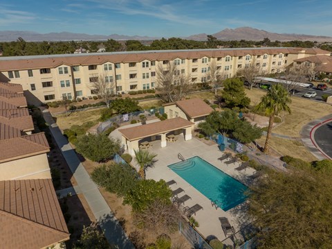 A pool in a courtyard surrounded by buildings.