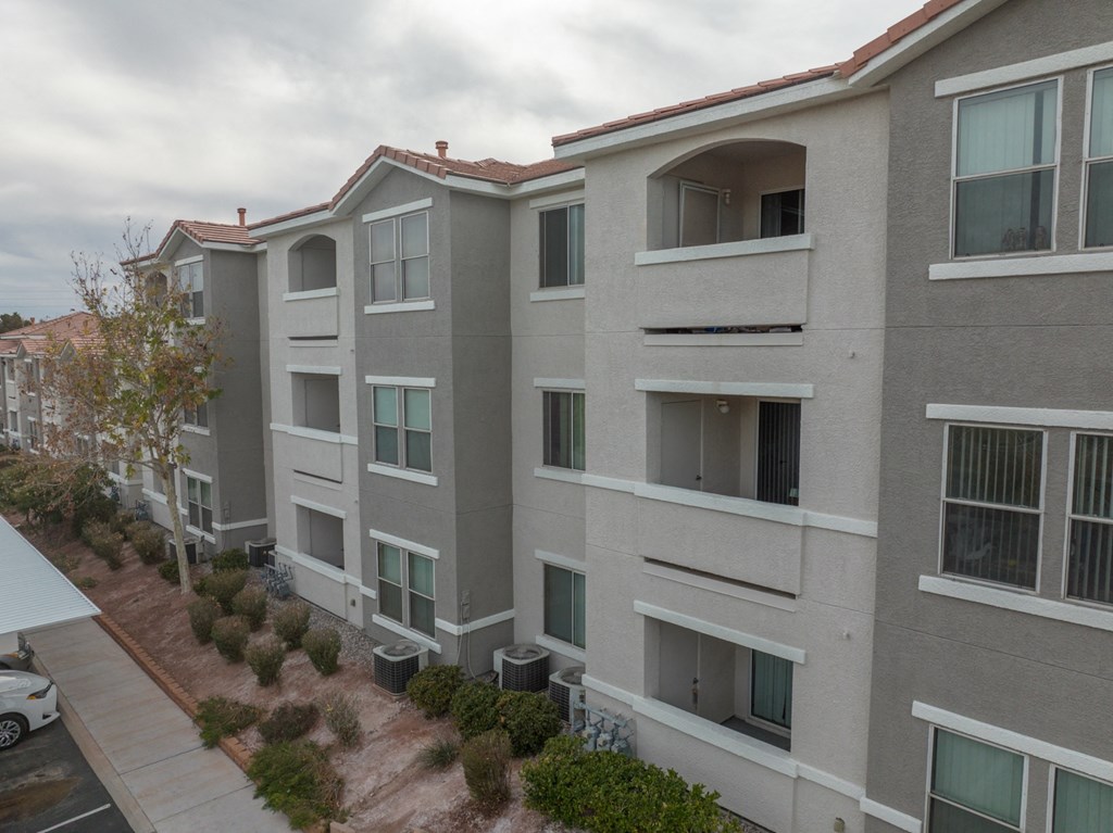 a row of apartment buildings with a street in front of them