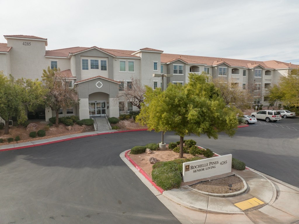 an empty parking lot in front of an apartment building