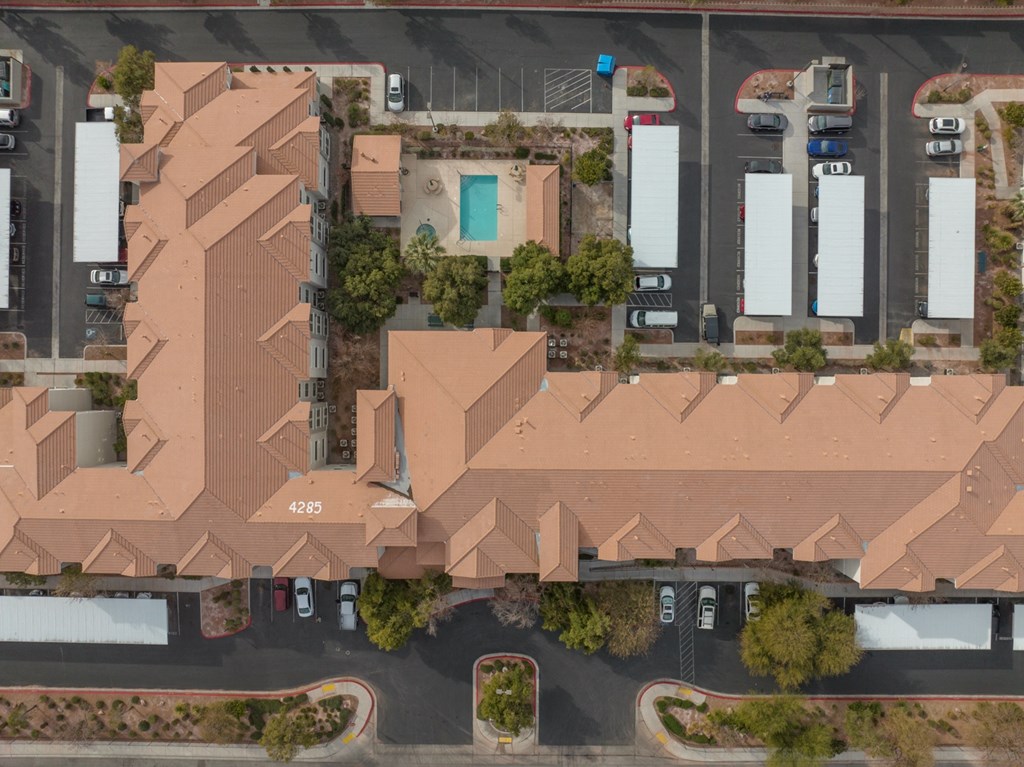 an aerial view of a neighborhood with houses and rooftops and cars