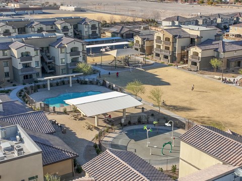 an aerial view of a community with a pool and buildings