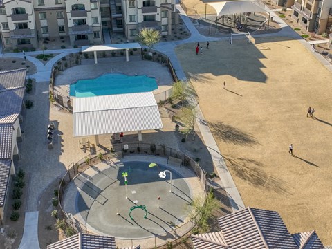 an aerial view of a playground and a pool in an apartment complex