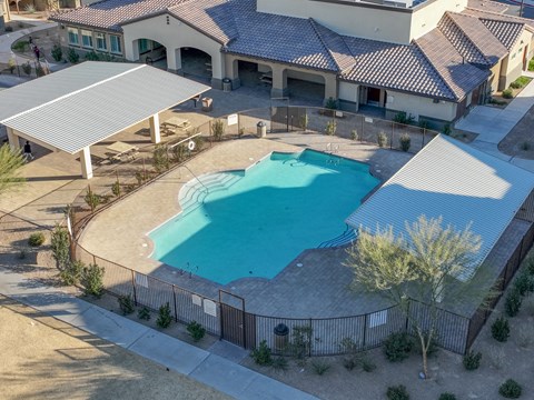 an aerial view of a swimming pool in front of a building