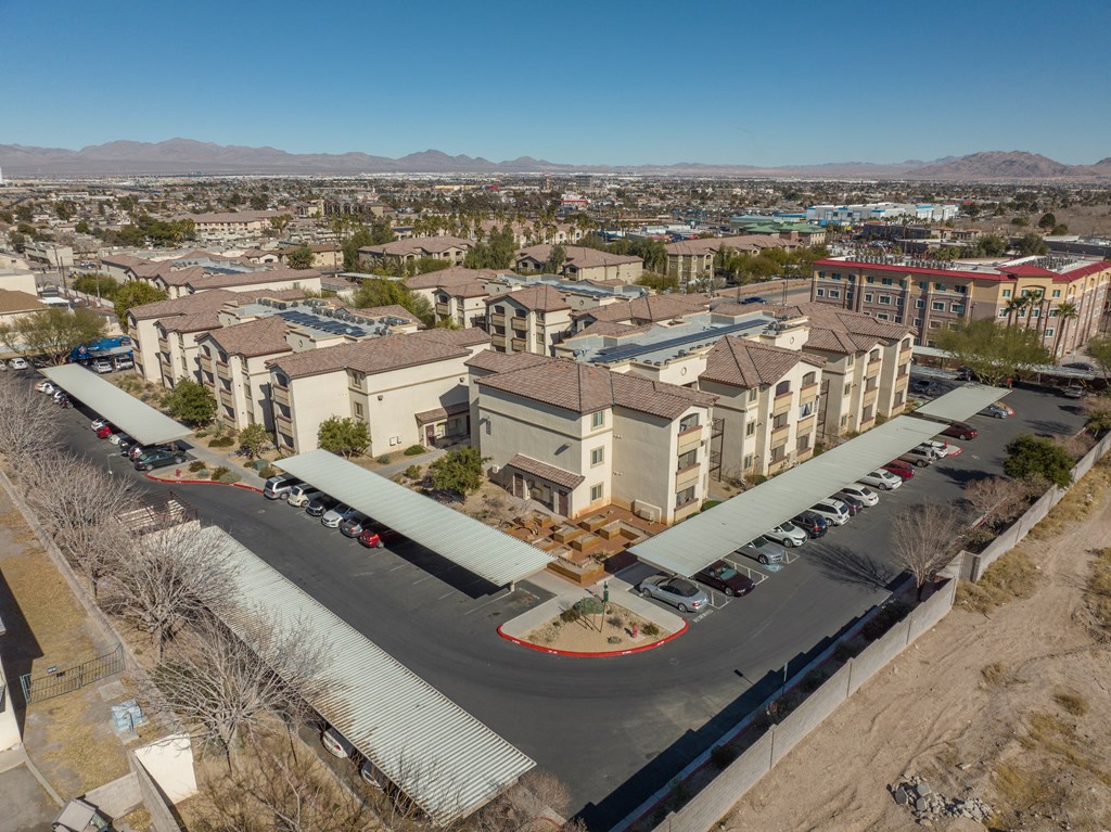 an aerial view of a city with buildings and a parking lot