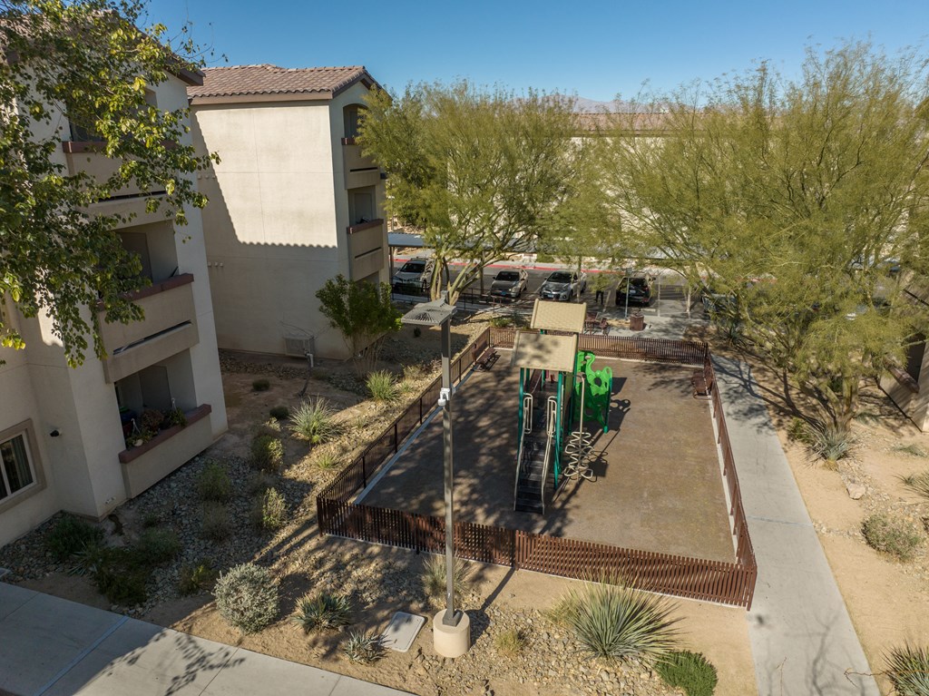 an aerial view of a courtyard with trees and buildings
