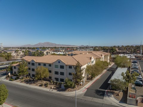 A view of a residential area with apartment buildings and a clear blue sky.