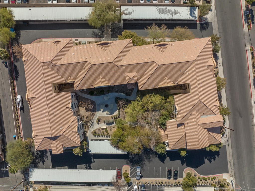 a birds eye view of a house with a roof and a parking lot