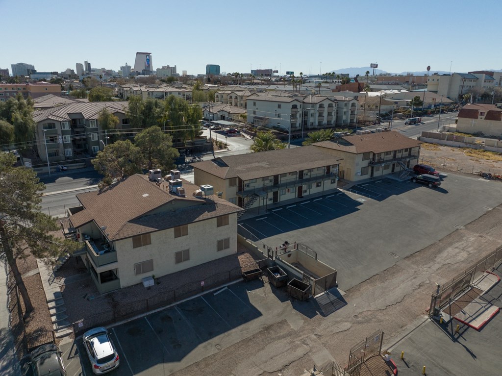an aerial view of a city with buildings and a parking lot