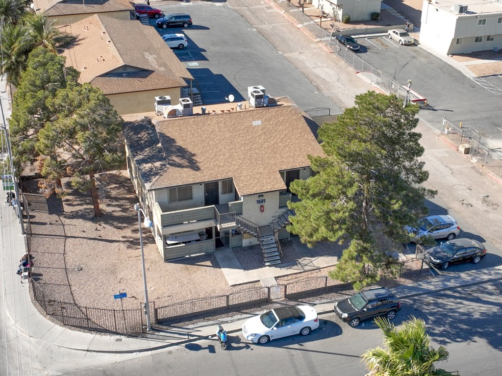 an aerial view of a house and cars parked in a parking lot