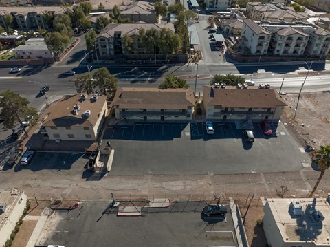 A parking lot with cars and a building in the background.